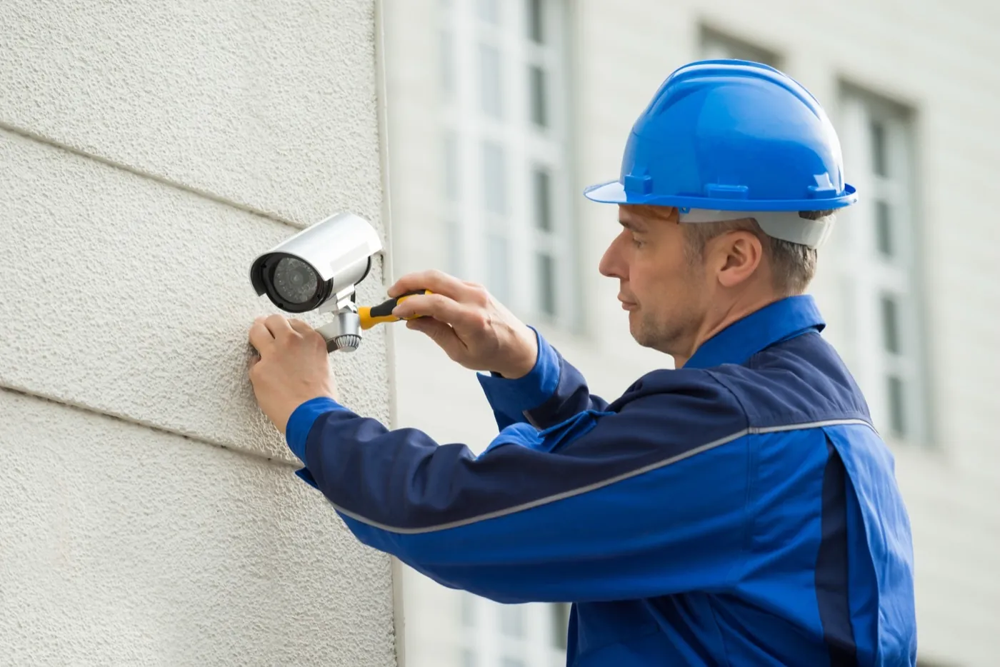Security engineer installing CCTV camera