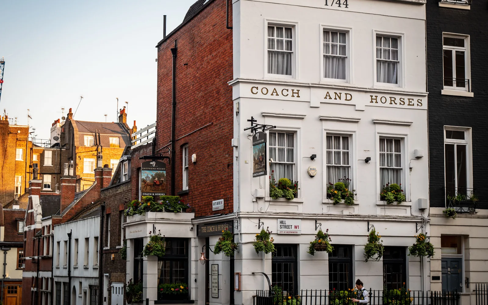 A London pub on a street corner, window boxes along the frontage
